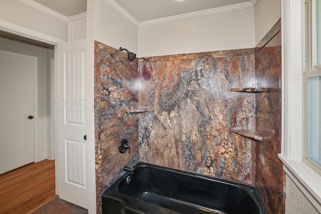 bathroom with hardwood / wood-style flooring, ornamental molding, and shower / washtub combination