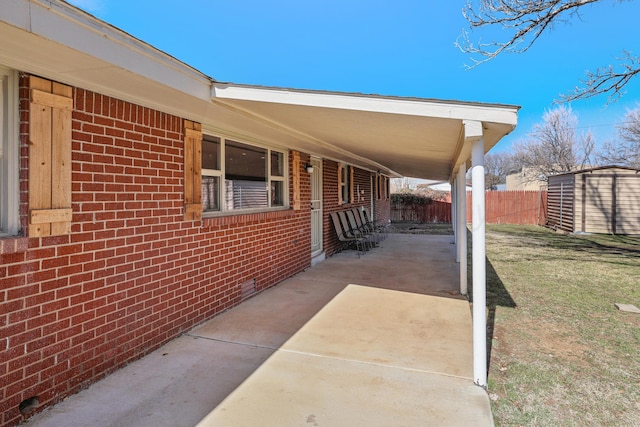 view of patio / terrace with a shed