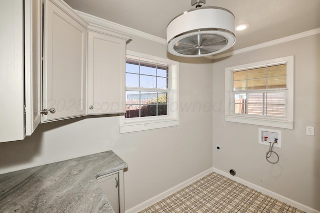 laundry area featuring electric dryer hookup, hookup for a washing machine, ornamental molding, and cabinets