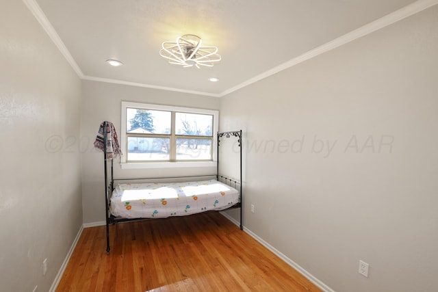 unfurnished bedroom with crown molding and wood-type flooring