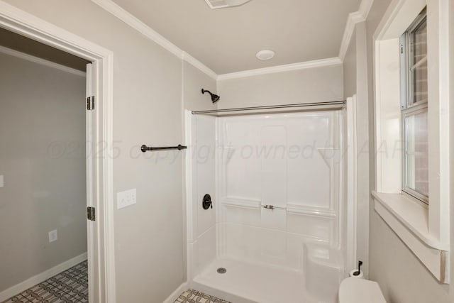 bathroom featuring ornamental molding, toilet, and a shower