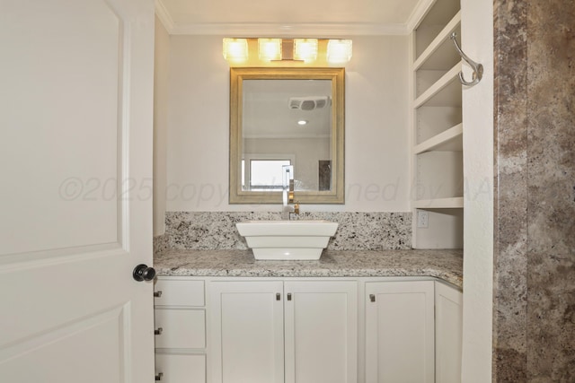 bathroom featuring crown molding and vanity