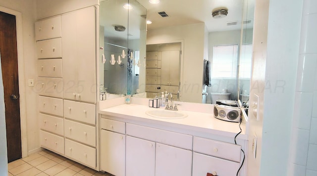 406 Bradley Ln, Dumas, TX 79029 - bathroom with vanity, toilet, and tile patterned flooring