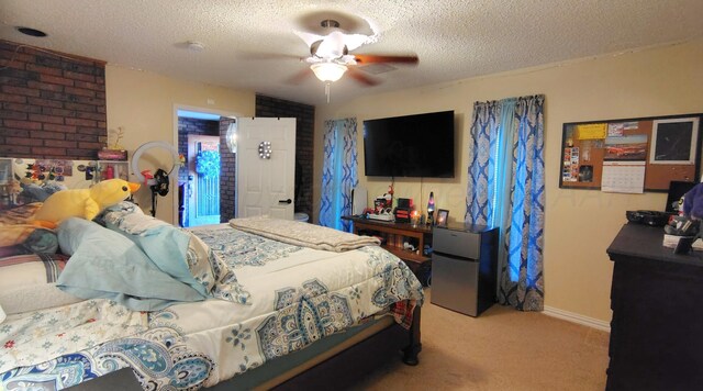 406 Bradley Ln, Dumas, TX 79029 - bedroom featuring ceiling fan, fridge, carpet flooring, and a textured ceiling