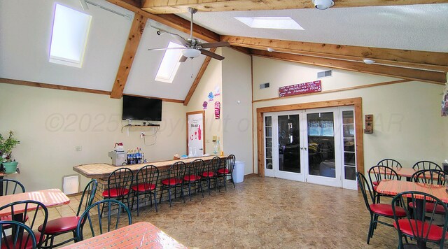 406 Bradley Ln, Dumas, TX 79029 - interior space featuring high vaulted ceiling, beamed ceiling, bar, ceiling fan, and french doors