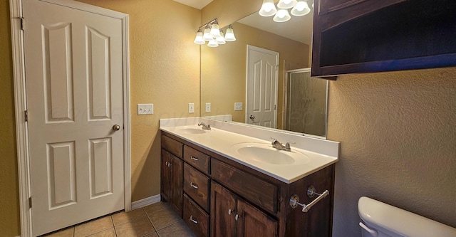 4207 Ross St, Amarillo, TX 79118 - full bath featuring a textured wall, tile patterned floors, double vanity, and a shower with door