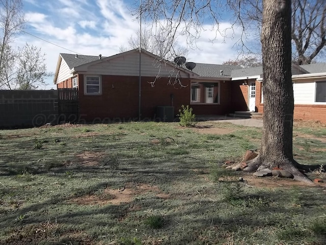 view of yard with fence and cooling unit