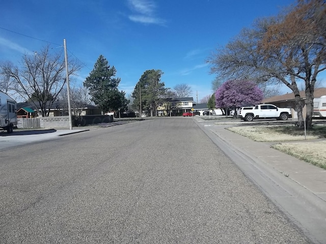 view of street with sidewalks and curbs