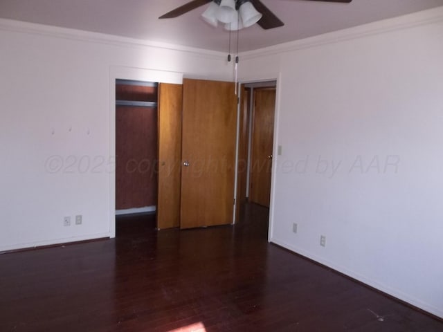 empty room featuring crown molding, baseboards, wood finished floors, and a ceiling fan