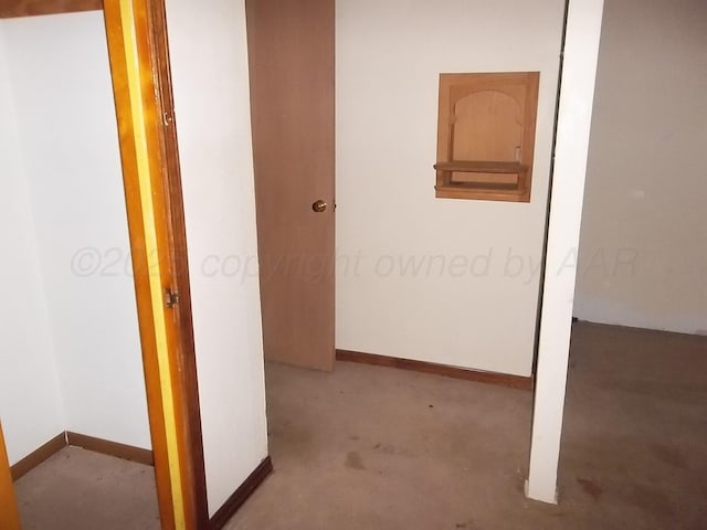 hall featuring baseboards