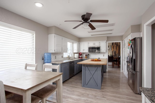 3506 Stromberg Pl, Amarillo, TX 79121 - kitchen featuring stainless steel appliances, butcher block counters, backsplash, white cabinets, and light wood-style flooring