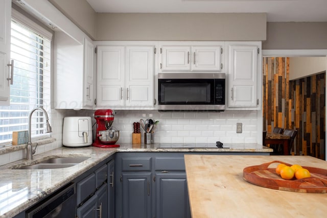 3506 Stromberg Pl, Amarillo, TX 79121 - kitchen featuring black appliances, white cabinets, decorative backsplash, and light stone counters