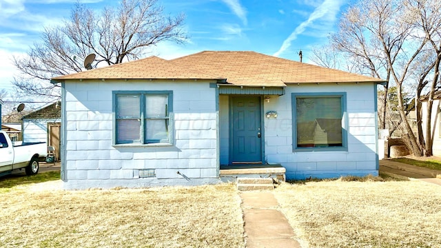 bungalow-style house with a front lawn