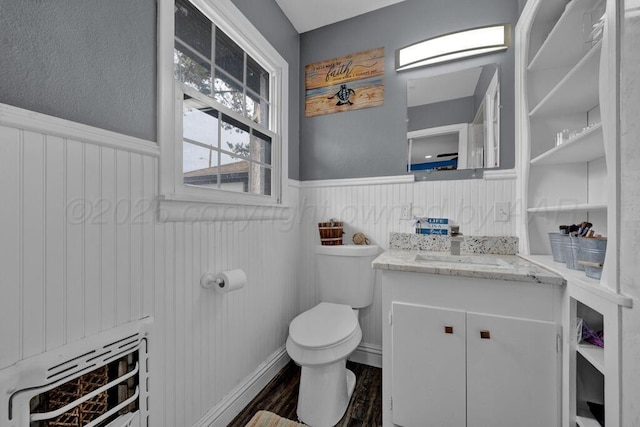 3701 Westlawn Ave, Amarillo, TX 79102 - half bath with wainscoting, heating unit, vanity, and wood finished floors