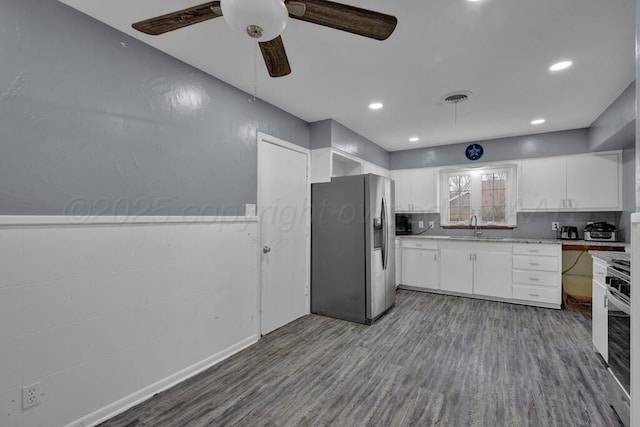 3701 Westlawn Ave, Amarillo, TX 79102 - kitchen featuring stainless steel appliances, dark wood-style flooring, white cabinets, and recessed lighting