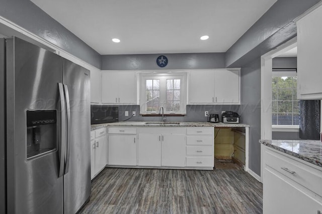 3701 Westlawn Ave, Amarillo, TX 79102 - kitchen with stainless steel fridge, dark wood-type flooring, white cabinetry, black microwave, and recessed lighting