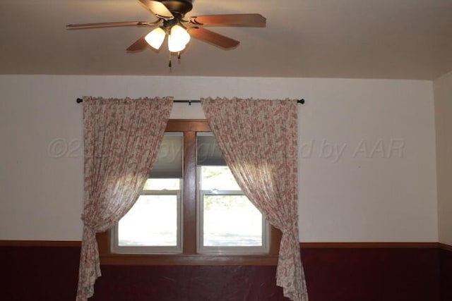 unfurnished room with baseboards and a ceiling fan