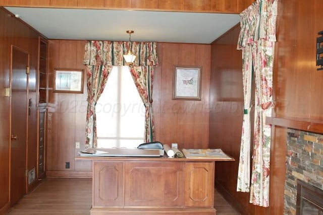 unfurnished office with light wood-style floors and wood walls