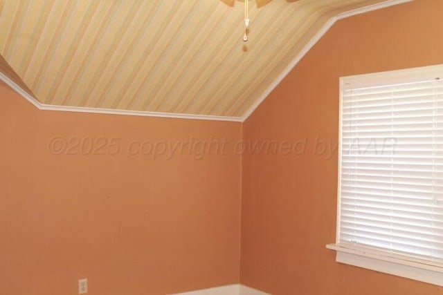 unfurnished room with vaulted ceiling and a ceiling fan