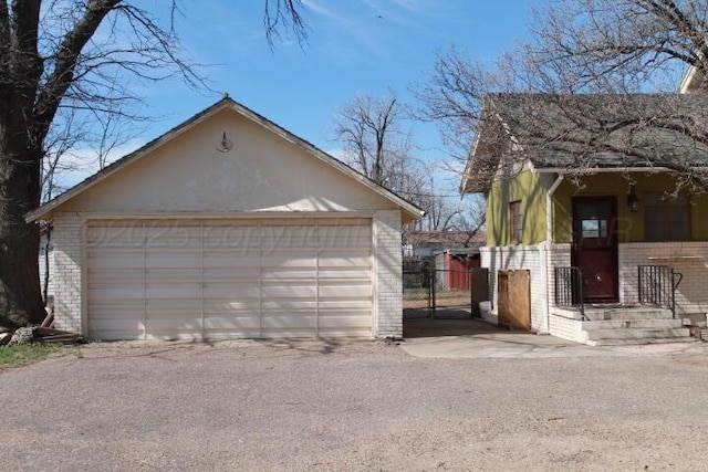 detached garage with a porch