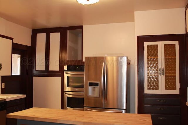 kitchen with appliances with stainless steel finishes and butcher block counters