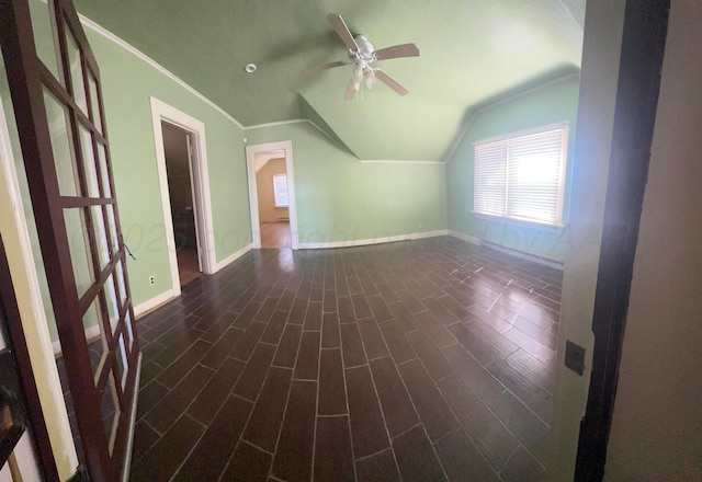 bonus room featuring vaulted ceiling, a ceiling fan, dark wood-style flooring, and baseboards