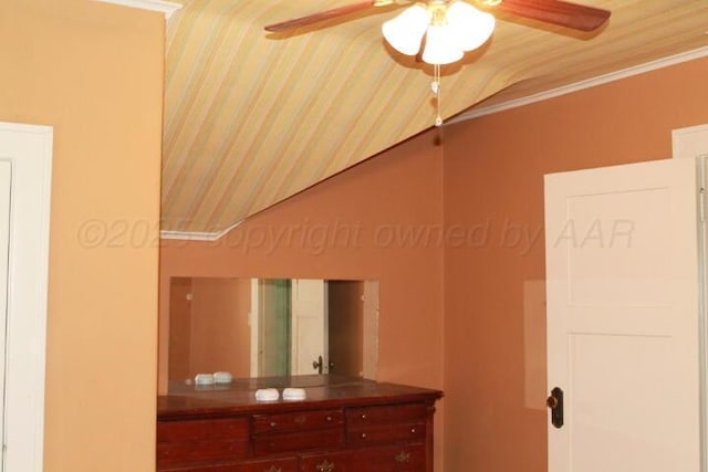 interior space with ceiling fan and crown molding