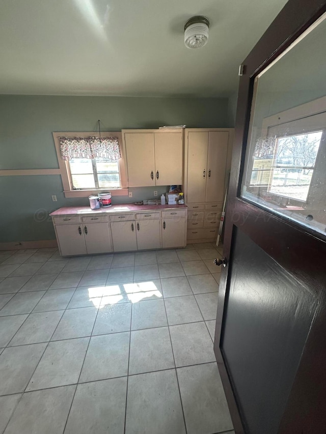 kitchen featuring light tile patterned floors and light countertops
