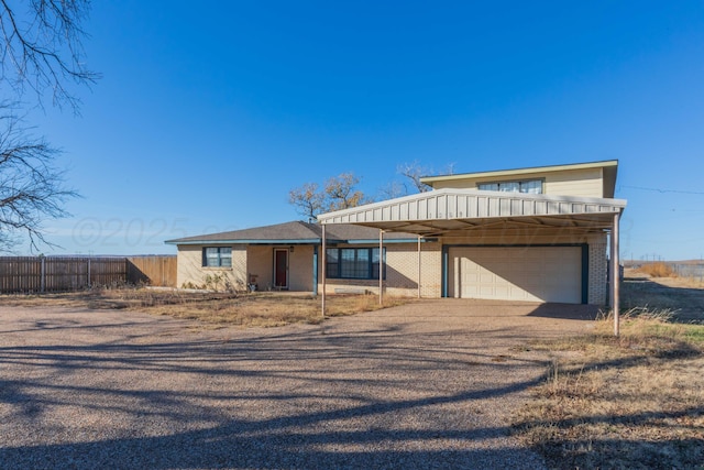 1209 S Main St, Shamrock, TX 79079 - view of front of property with a garage, driveway, and a carport