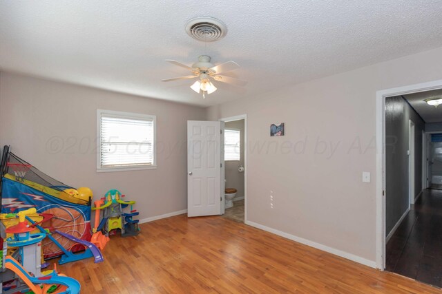 1209 S Main St, Shamrock, TX 79079 - game room featuring wood finished floors, ceiling fan, and a textured ceiling