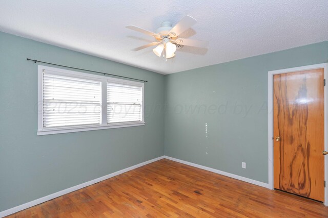 1209 S Main St, Shamrock, TX 79079 - unfurnished bedroom featuring wood finished floors and ceiling fan