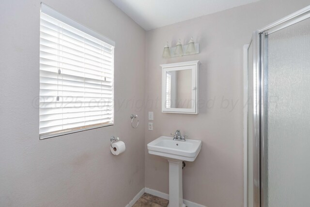1209 S Main St, Shamrock, TX 79079 - bathroom featuring a shower stall and a sink
