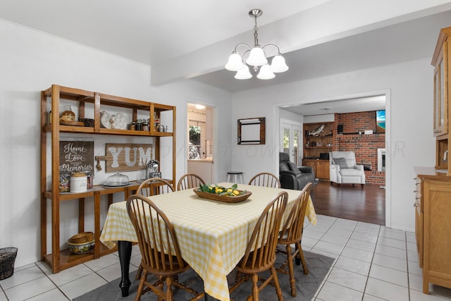 dining space with light hardwood / wood-style floors and a chandelier