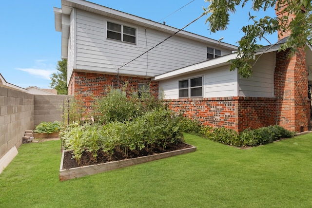 rear view of property with a yard