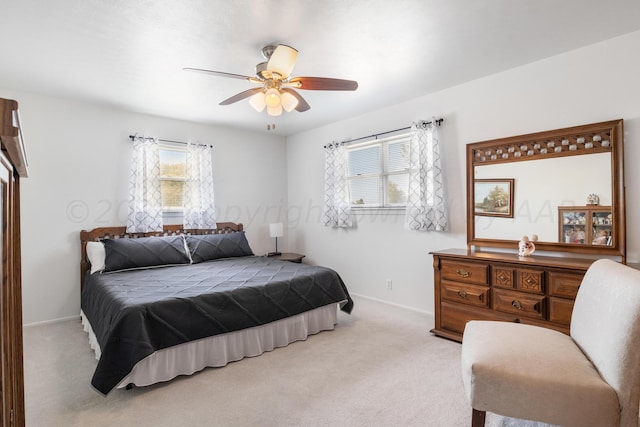 bedroom with ceiling fan and light colored carpet