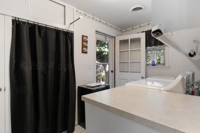 bathroom featuring washing machine and dryer