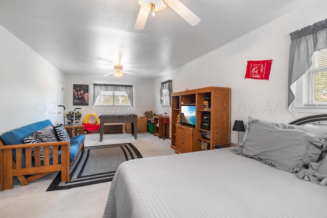 bedroom featuring light colored carpet and ceiling fan