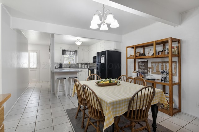 dining area featuring beamed ceiling, a chandelier, and light tile patterned floors