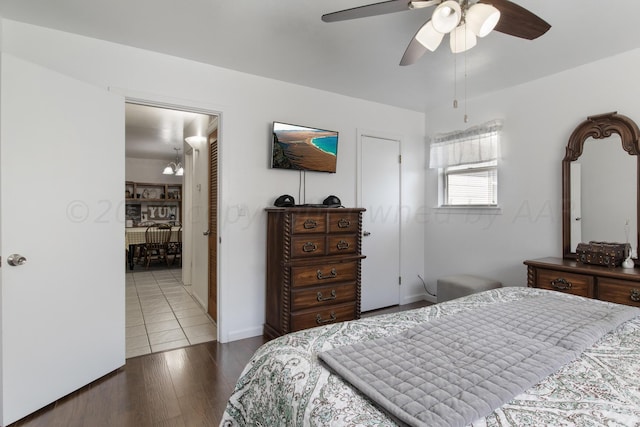 bedroom with ceiling fan and dark hardwood / wood-style flooring