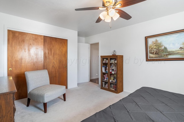 carpeted bedroom with ceiling fan and a closet