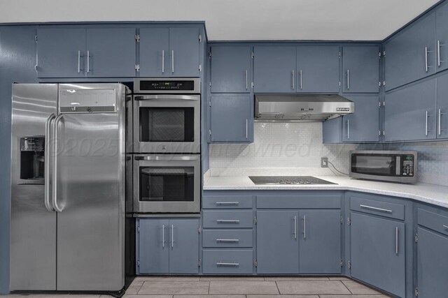 3412 Sunlite St, Amarillo, TX 79109 - kitchen featuring appliances with stainless steel finishes, under cabinet range hood, light countertops, tasteful backsplash, and blue cabinets