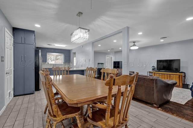 3412 Sunlite St, Amarillo, TX 79109 - dining room featuring wood tiled floors, recessed lighting, and a chandelier