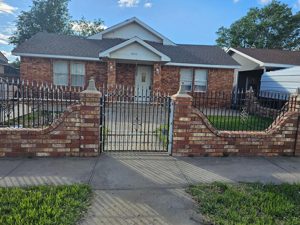 3003 Ridgemere Blvd, Amarillo, TX 79107 - ranch-style house with a fenced front yard, brick siding, roof with shingles, and a gate