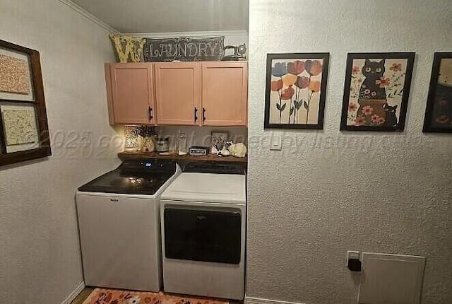 washroom featuring washer and dryer, cabinet space, ornamental molding, and a textured wall