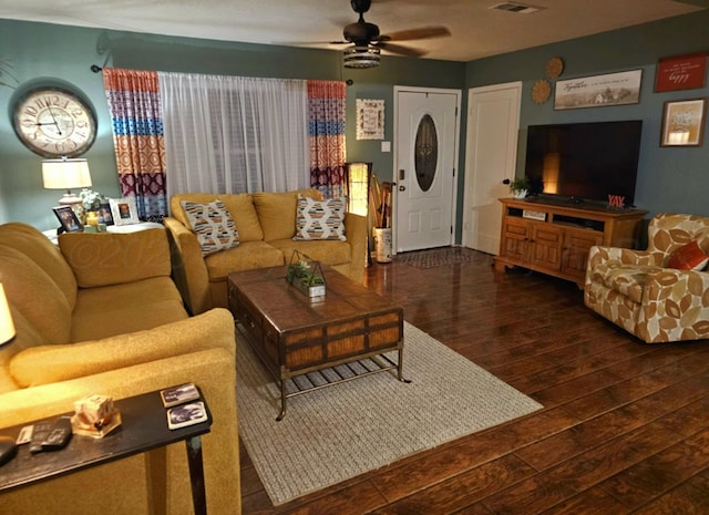 living area with visible vents, wood-type flooring, and a ceiling fan