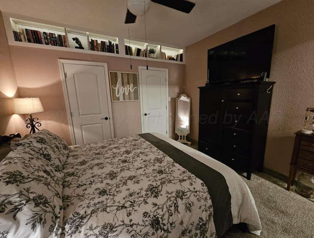 bedroom featuring carpet flooring, a ceiling fan, and a textured wall