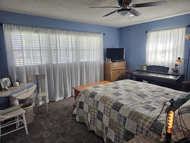 bedroom featuring multiple windows, a textured ceiling, carpet, and ceiling fan