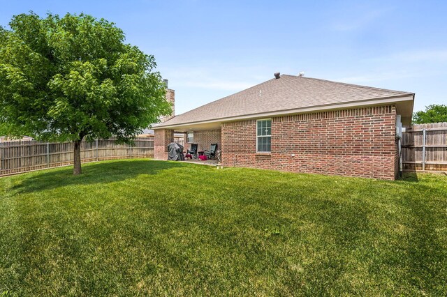 9315 Shylana Ave, Amarillo, TX 79119 - rear view of house with brick siding, a shingled roof, and a chimney
