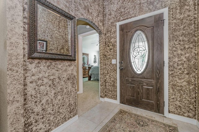 9315 Shylana Ave, Amarillo, TX 79119 - foyer entrance featuring wallpapered walls, arched walkways, baseboards, and light tile patterned flooring