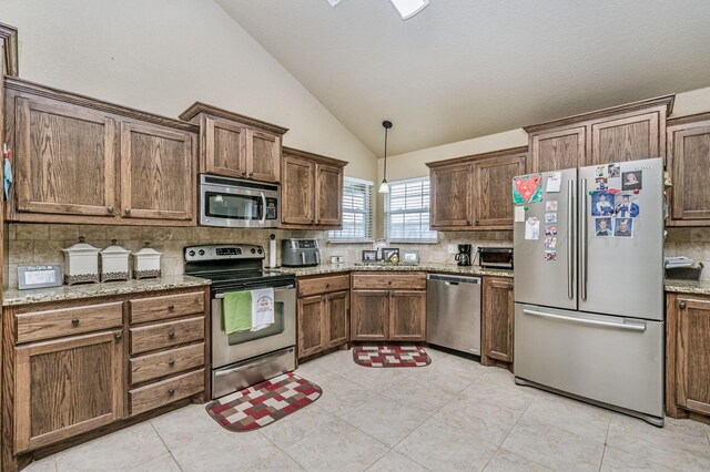 9315 Shylana Ave, Amarillo, TX 79119 - kitchen featuring appliances with stainless steel finishes, vaulted ceiling, backsplash, and light stone countertops
